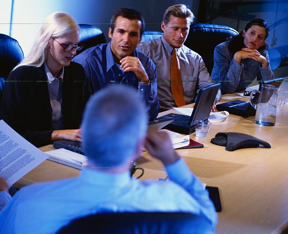 Lebal Drocer executives discuss the best approach to exploit Topiary's indictment while celebrating "bring-your-wives-to-work-day."